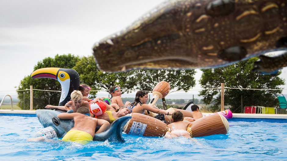 Pequeños disfrutando de hinchables en la piscina. Fuente: AC